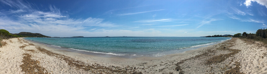 Wide angle view of an empty Corsican beach on mediterranean sea