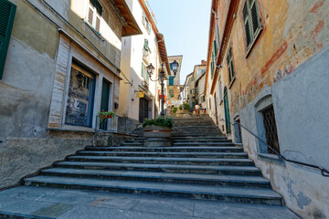 Fototapeta na wymiar Ovada, Piedmont, Italy - June 27, 2021: staircase leading from Piazza Castello to the historic center of the town