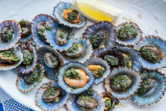 "Lapas" or true limpets with green moyo - traditional seafood of Tenerife and Madeira Islands.