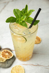 non-alcoholic cocktail, lemonade. With mint, ice, lime on a gray table