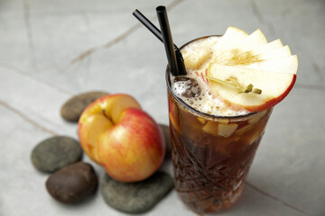 non-alcoholic refreshing cocktail in the heat, lemonade. With ice on a gray table
