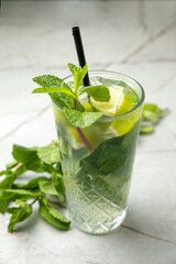 non-alcoholic cocktail, lemonade. With mint, ice, lime on a gray table