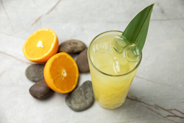 non-alcoholic refreshing cocktail in the heat, lemonade. With ice on a gray table
