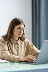 Beautiful business woman is looking at camera and smiling while working in office