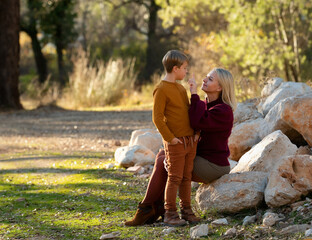 Fototapeta premium Mom and son have a nice chat in the autumn season.