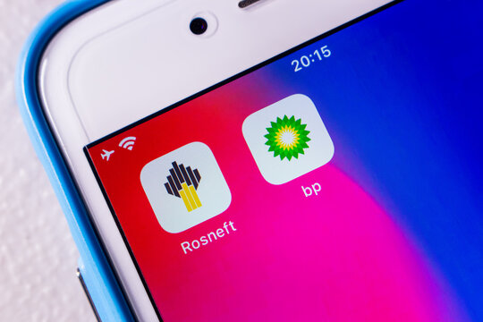 Kumamoto, JAPAN - Mar 14 2022 : Conceptual icons of Rosneft (PJSC Rosneft Oil Company) and BP plc (formerly The British Petroleum Company plc and BP Amoco plc) on an iPhone.
