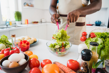 Cropped photo of young make homemade yummy veggie supper dish mix salad table in kitchen house indoors
