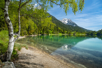 Wilder Kaiser mountain range reflected in idyllic Hintersteiner See, Scheffau, Tyrol, Austria, Europe