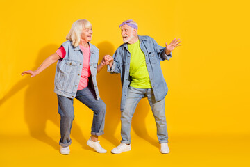 Photo of funky pretty girlfriend boyfriend dressed denim outfit having fun empty space isolated yellow color background