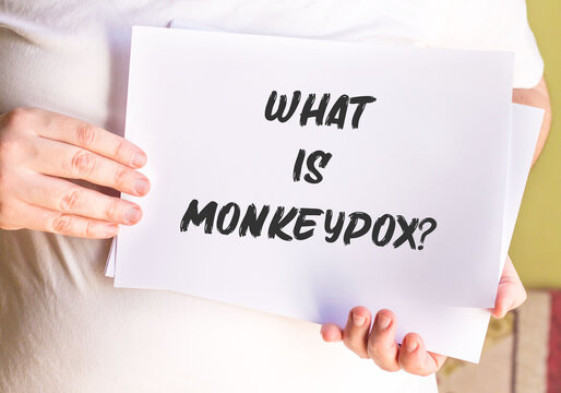 " What is monkeypox? " is on a banner in men's hands