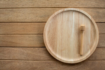 Brown wooden plate on a rustic table close-up Horizontal top view. have copy space