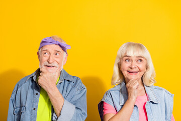 Photo of charming retired husband wife wear jeans clothes arms chin looking empty space isolated yellow color background