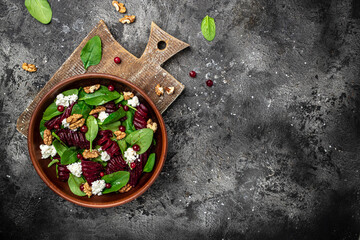 Fototapeta na wymiar Healthy Beet Salad with fresh sweet baby spinach, cheese, nuts, cranberries. Clean eating, dieting, vegan food concept. Long banner format. top view