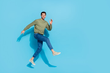Fototapeta na wymiar Full body photo of excited crazy person hurry rush fast empty space isolated on blue color background