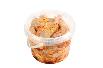 Raw marinated quails in a plastic bucket