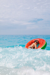woman going to swim with inflatable ring