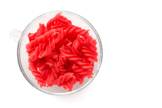 Close-up background of Fusille and Rotini in a glass bowl on white. pasta