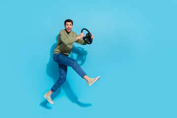 Fototapeta na wymiar Full length photo of funky millnnial brunet guy run drive wear shirt jeans footwear isolated on blue background