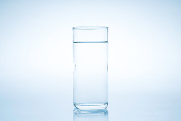 Ice cube fell into the glass of water.Water splashed from the clear glass.Fresh concept