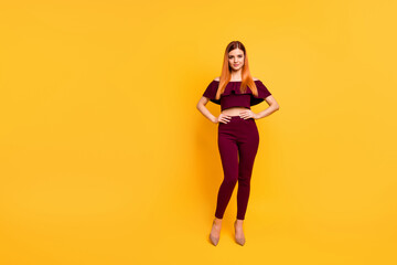 Full size photo of adorable nice lady put hands waist stand posing isolated on yellow color background