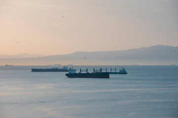 View of cargo ships at sunset in the Strait of Gibraltar