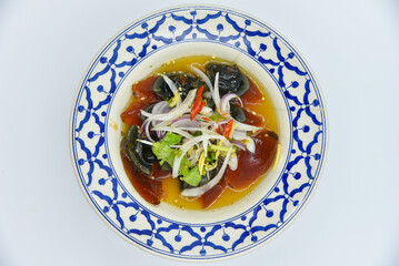 Spicy Century Egg Salad - Thai food, top view on white background.