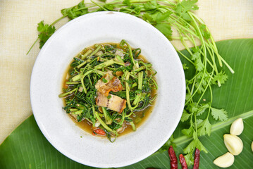 Stir-fried Water Mimosa with Crispy Pork - Thai food, top view on white background.