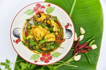 Stir-fried Spicy Red Tail Catfish with Fingerroot - Thai food, top view on white background.