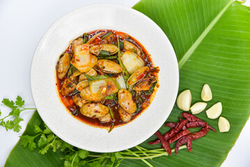 Stir-fried Clams with Roasted Chili Paste - Thai food, top view on white background.