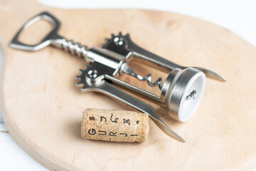 corkscrew and cork on wood background