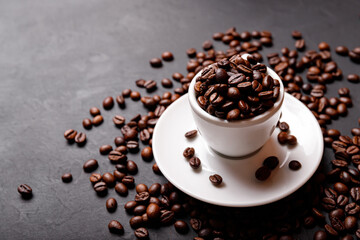 Hot fresh black coffee with milk foam for morning menu in white ceramic cup with coffee beans roasted on.