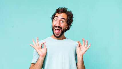 young adult hispanic crazy man expressing a emotion with a copy space - obrazy, fototapety, plakaty