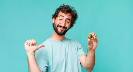 Fototapeta young adult hispanic crazy man with a bitcoin coin obraz