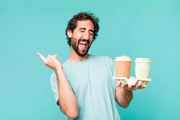 young adult hispanic crazy man. delivery take away coffees concept - obrazy, fototapety, plakaty