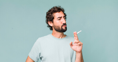 Fototapeta young adult hispanic crazy man with a cigarette obraz