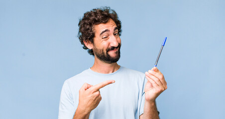 young adult hispanic crazy man with a pen - obrazy, fototapety, plakaty