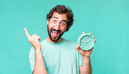 young adult hispanic crazy man with an alarm clock