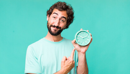 young adult hispanic crazy man with an alarm clock