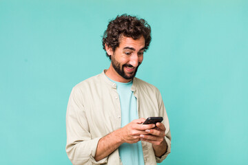 young adult hispanic crazy man using his phone