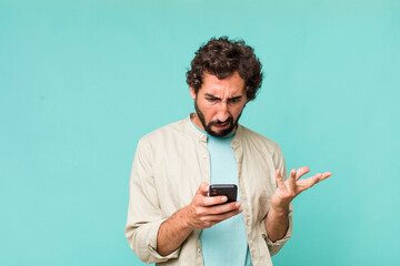 young adult hispanic crazy man using his phone