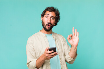 young adult hispanic crazy man using his phone