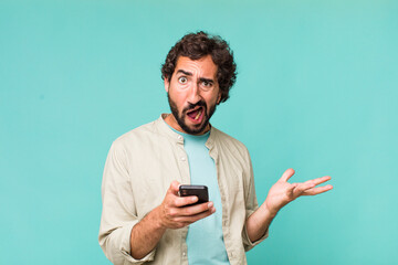 young adult hispanic crazy man using his phone