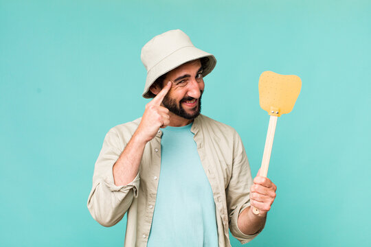 Young Adult Hispanic Crazy Man With A Fly Swatter