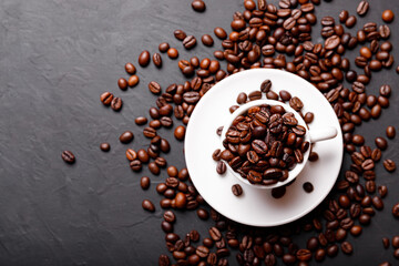 Hot fresh black coffee with milk foam for morning menu in white ceramic cup with coffee beans roasted on.