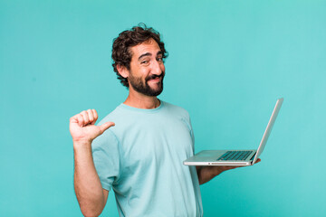 young adult hispanic crazy man with a laptop