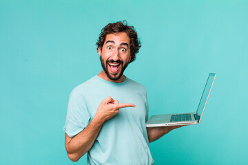 Fototapeta young adult hispanic crazy man with a laptop obraz