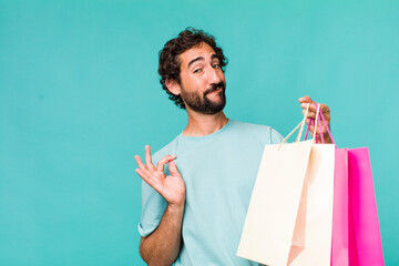 young adult hispanic crazy man. shopping bags concept