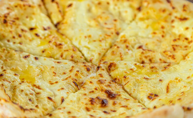 Georgian cuisine Megrelian khachapuri on the table. Selective focus.