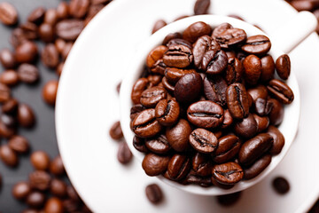 Hot fresh black coffee with milk foam for morning menu in white ceramic cup with coffee beans roasted on.