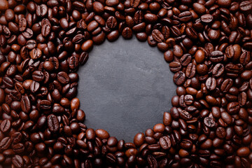 Hot fresh black coffee with milk foam for morning menu in white ceramic cup with coffee beans roasted on.